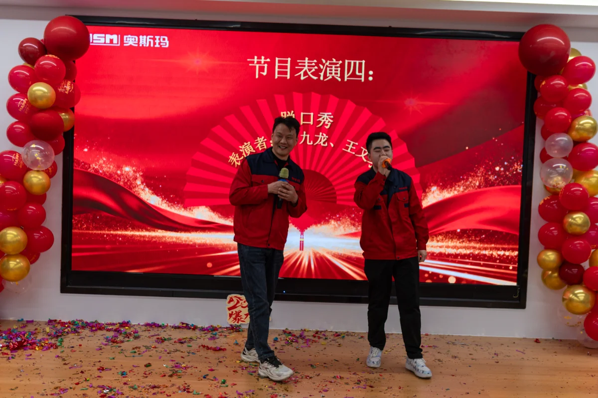 Two OSM employees perform a stand-up comedy routine at the 2026 Annual Meeting. This team-building event highlights company culture and employee engagement, showcasing the vibrant spirit of the OSM manufacturing team.