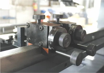 Close-up of OSM press brake manual backgauge assembly, highlighting precision mechanical structure and ergonomic design.