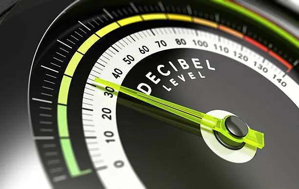 OSM environmental management with decibel meter showing low noise levels, highlighting commitment to quiet production environment.