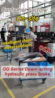 OSM OG Series Down-acting hydraulic press brake in operation. This intelligent sheet metal solution is shown on-site at a customer factory, highlighting heavy-duty industrial forming capabilities.